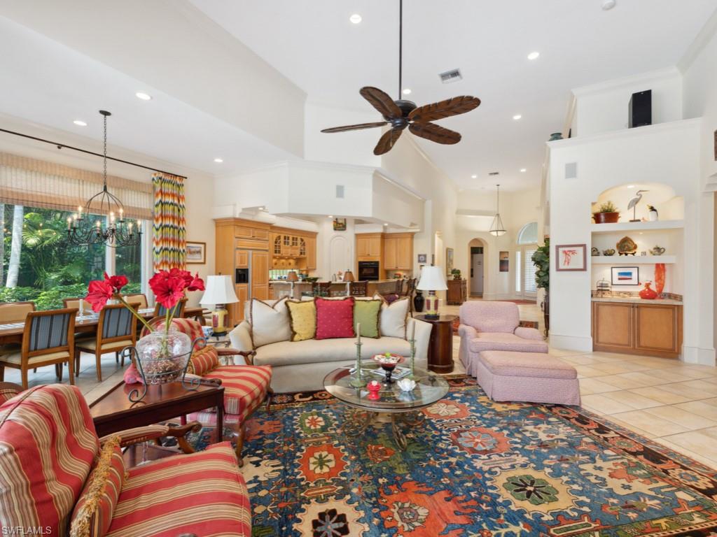 15352 Milan Lane Naples, FL 34110 - Photo 10 of 49 a living room with lots of furniture and a chandelier
