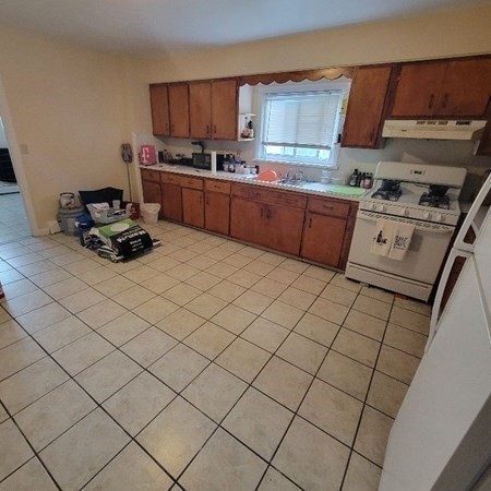 134 Fountain Street Fall River, MA 02721 - Photo 8 of 11 a kitchen with stainless steel appliances a sink stove and cabinets