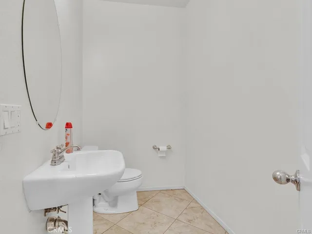 a bathroom with a granite countertop sink a mirror and a bathtub