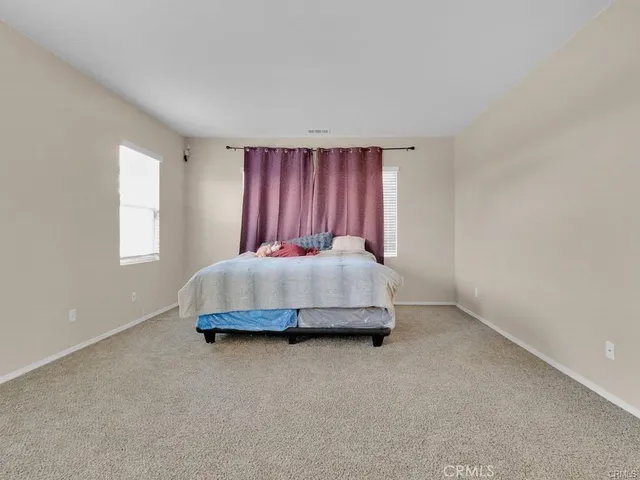 a view of walk in closet with clothes