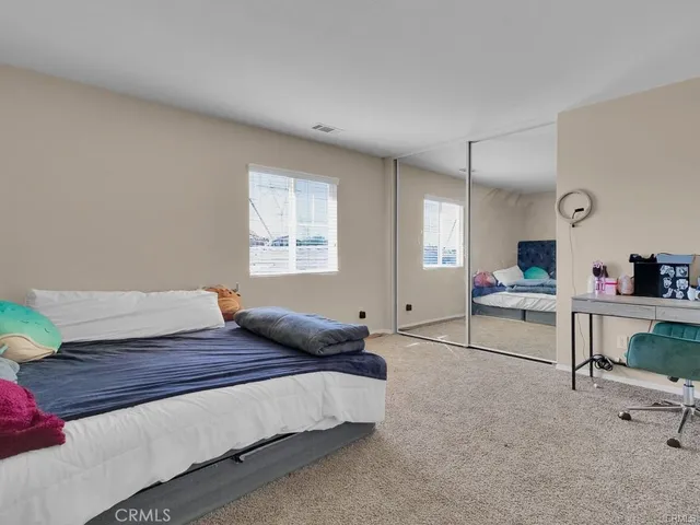 a spacious bathroom with a granite countertop tub a sink and a chandelier