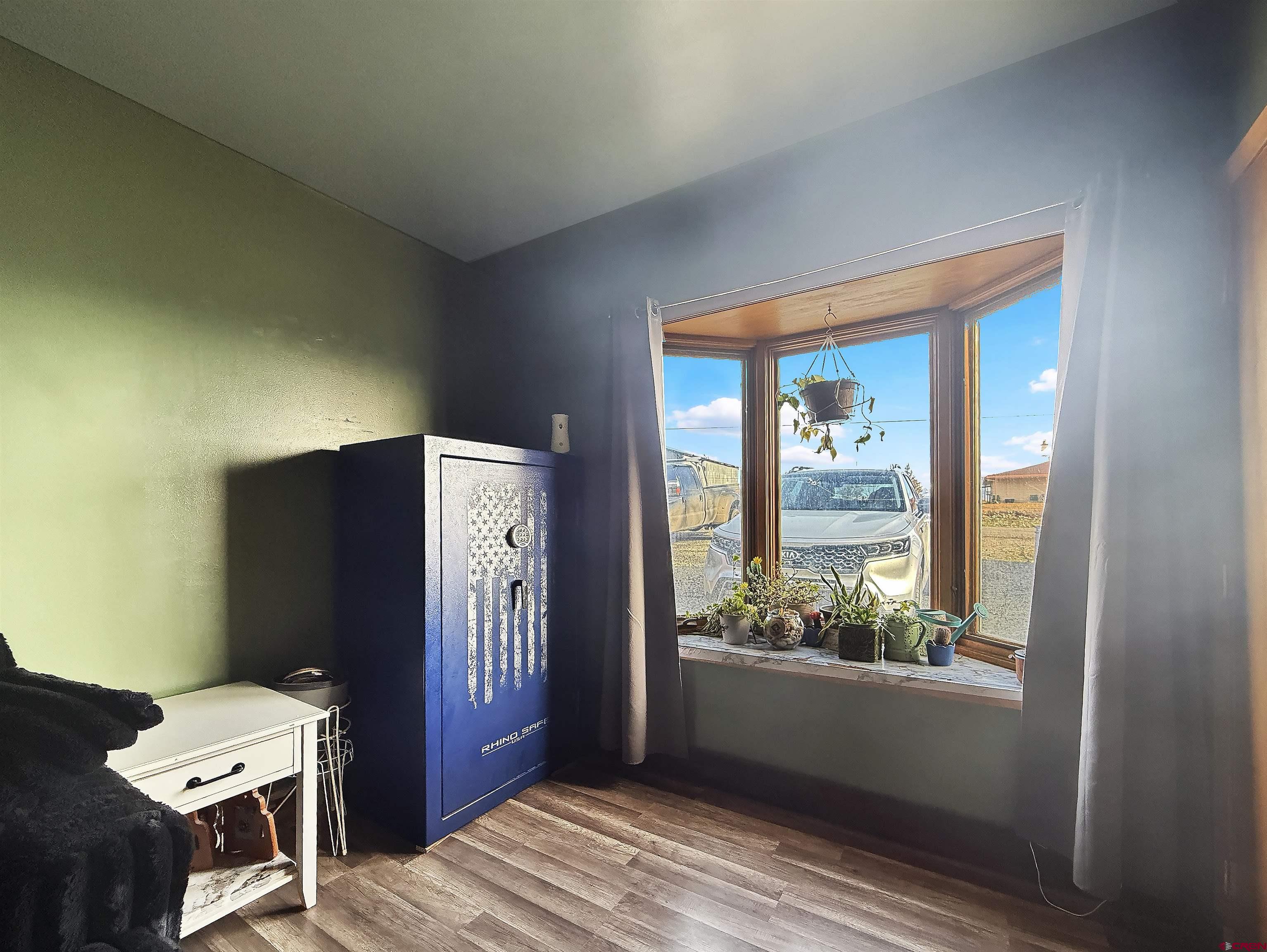 10659 3100th Road Hotchkiss, CO 81419 - Photo 11 of 40 a view of a hallway to a livingroom with furniture wooden floor and windows