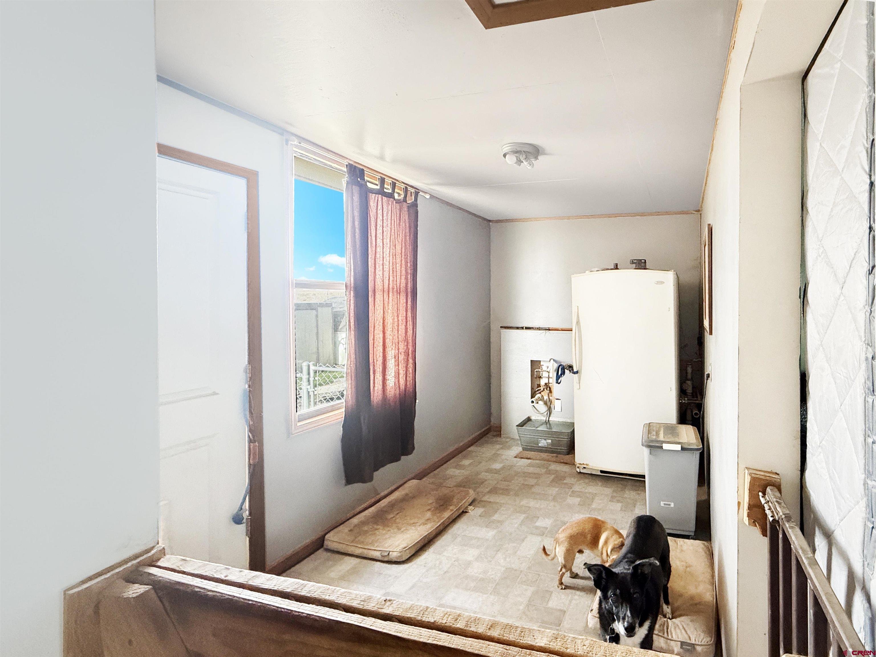 10659 3100th Road Hotchkiss, CO 81419 - Photo 22 of 40 a room with a refrigerator and a window