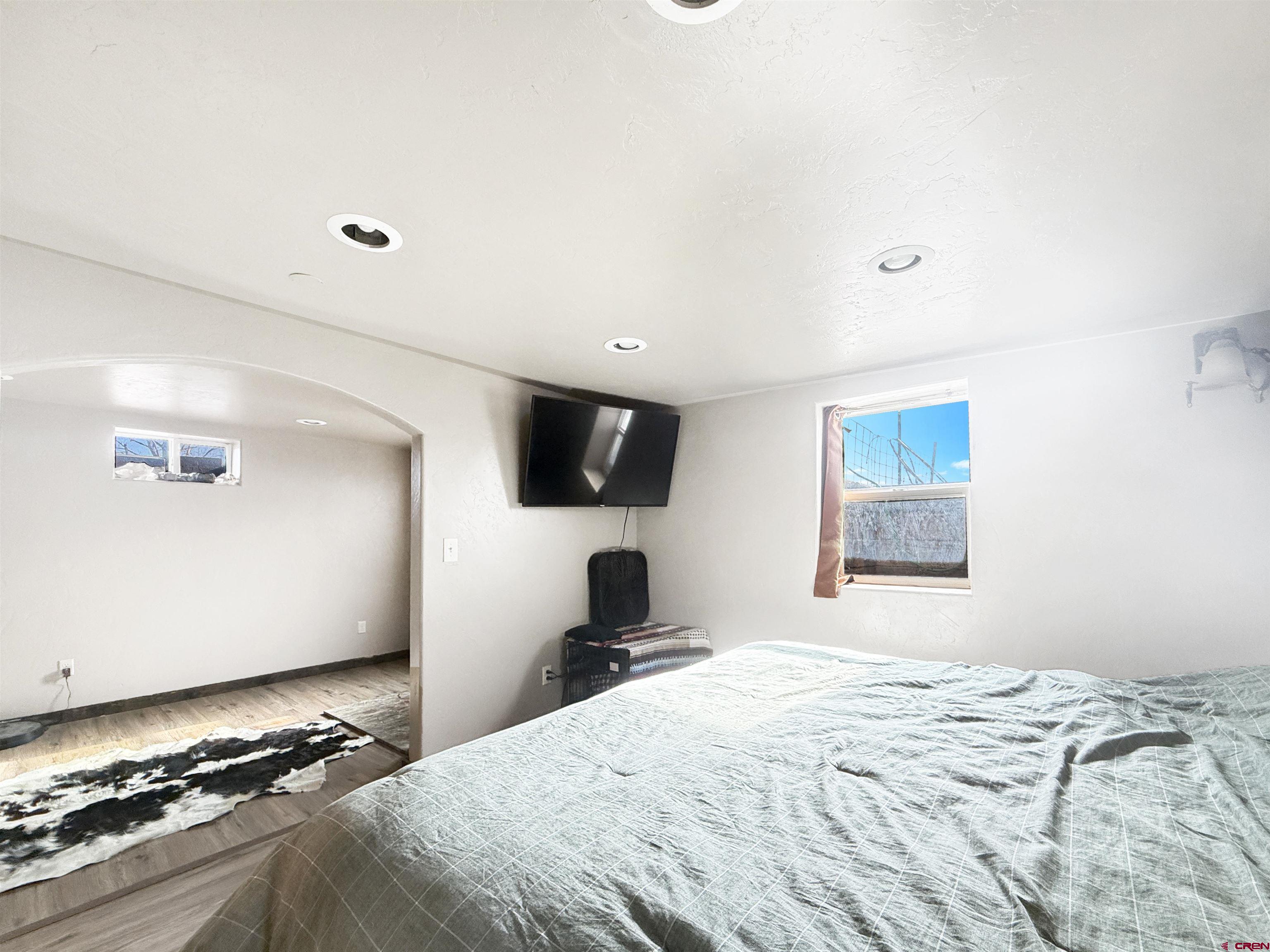 10659 3100th Road Hotchkiss, CO 81419 - Photo 28 of 40 a bedroom with a bed and a flat screen tv
