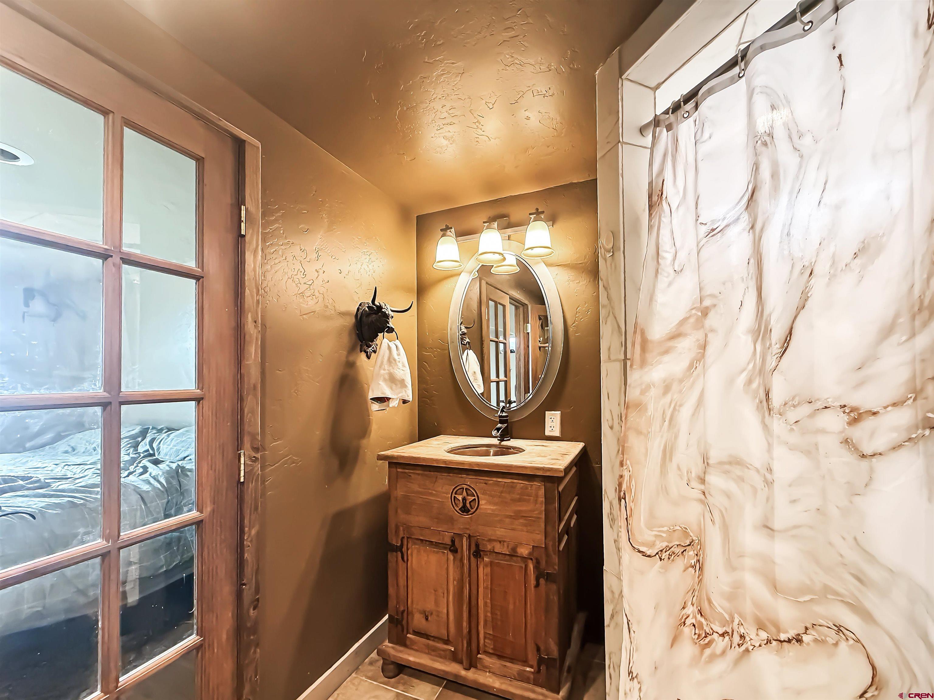 10659 3100th Road Hotchkiss, CO 81419 - Photo 30 of 40 a view of walk in closet with clothes and shoes