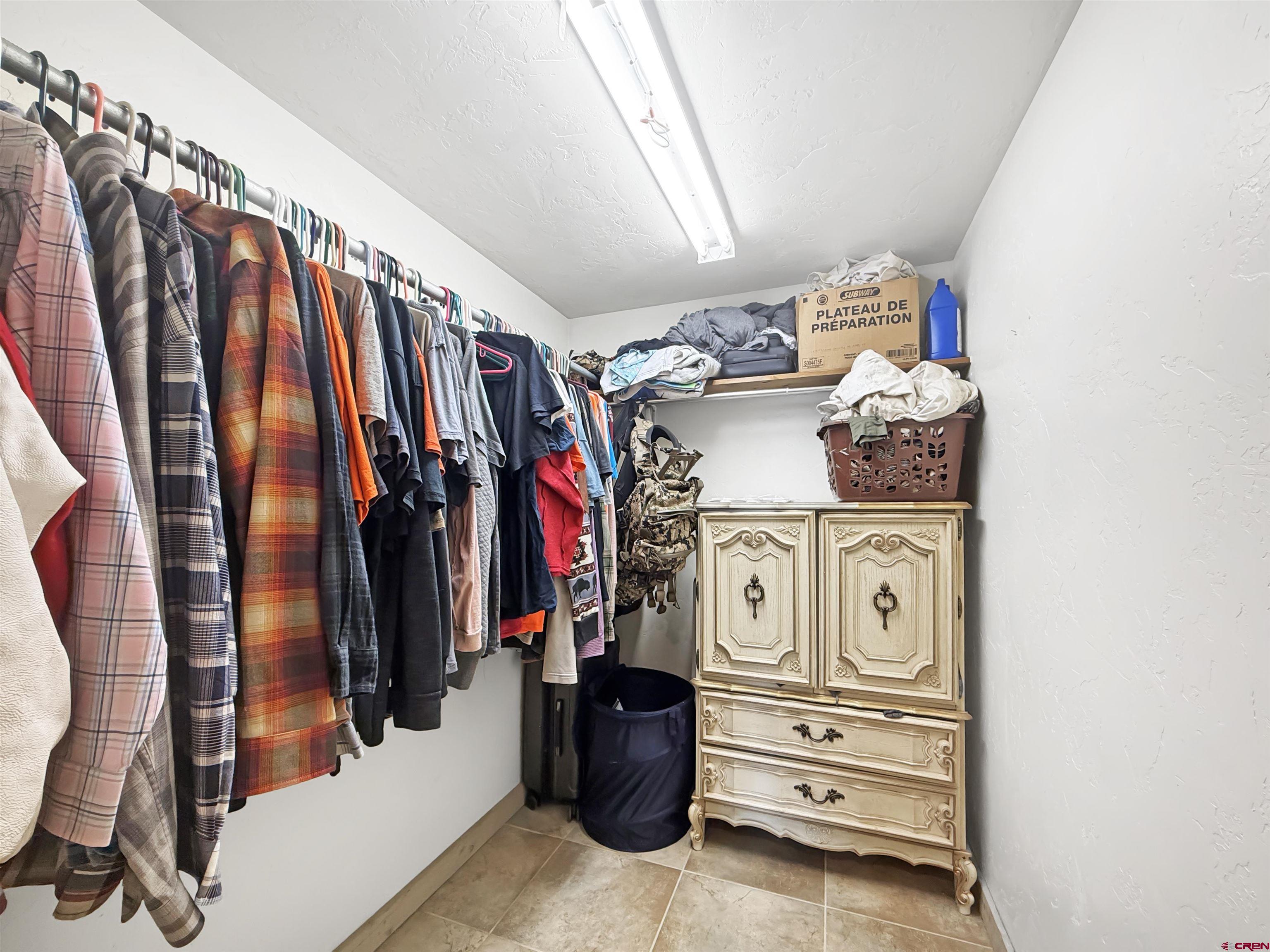 10659 3100th Road Hotchkiss, CO 81419 - Photo 31 of 40 a view of walk in closet with clothes and shoes
