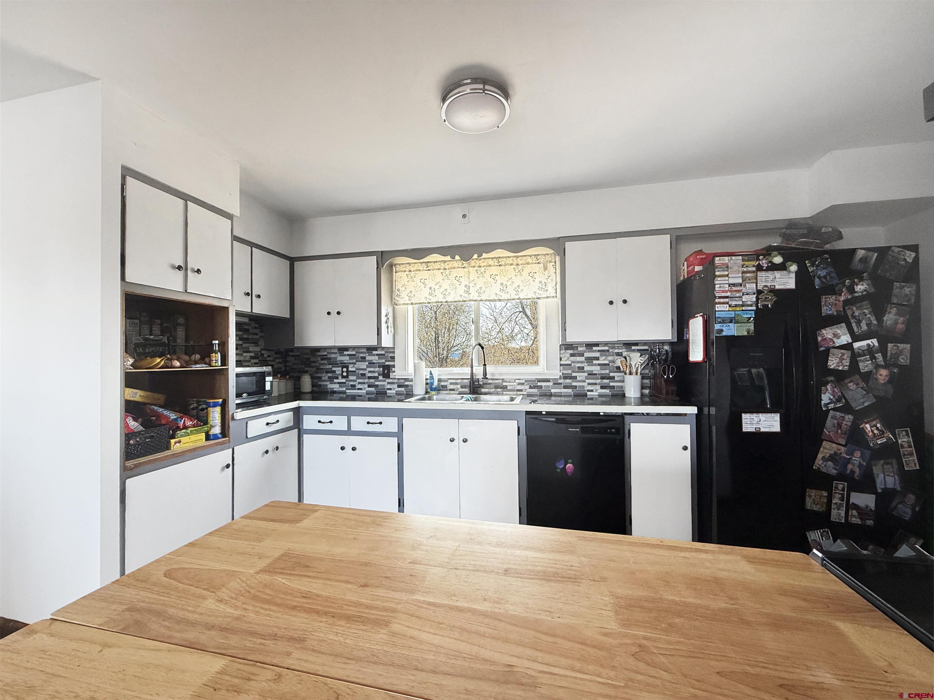 10659 3100th Road Hotchkiss, CO 81419 - Photo 5 of 40 a kitchen with granite countertop a refrigerator stove top oven and sink