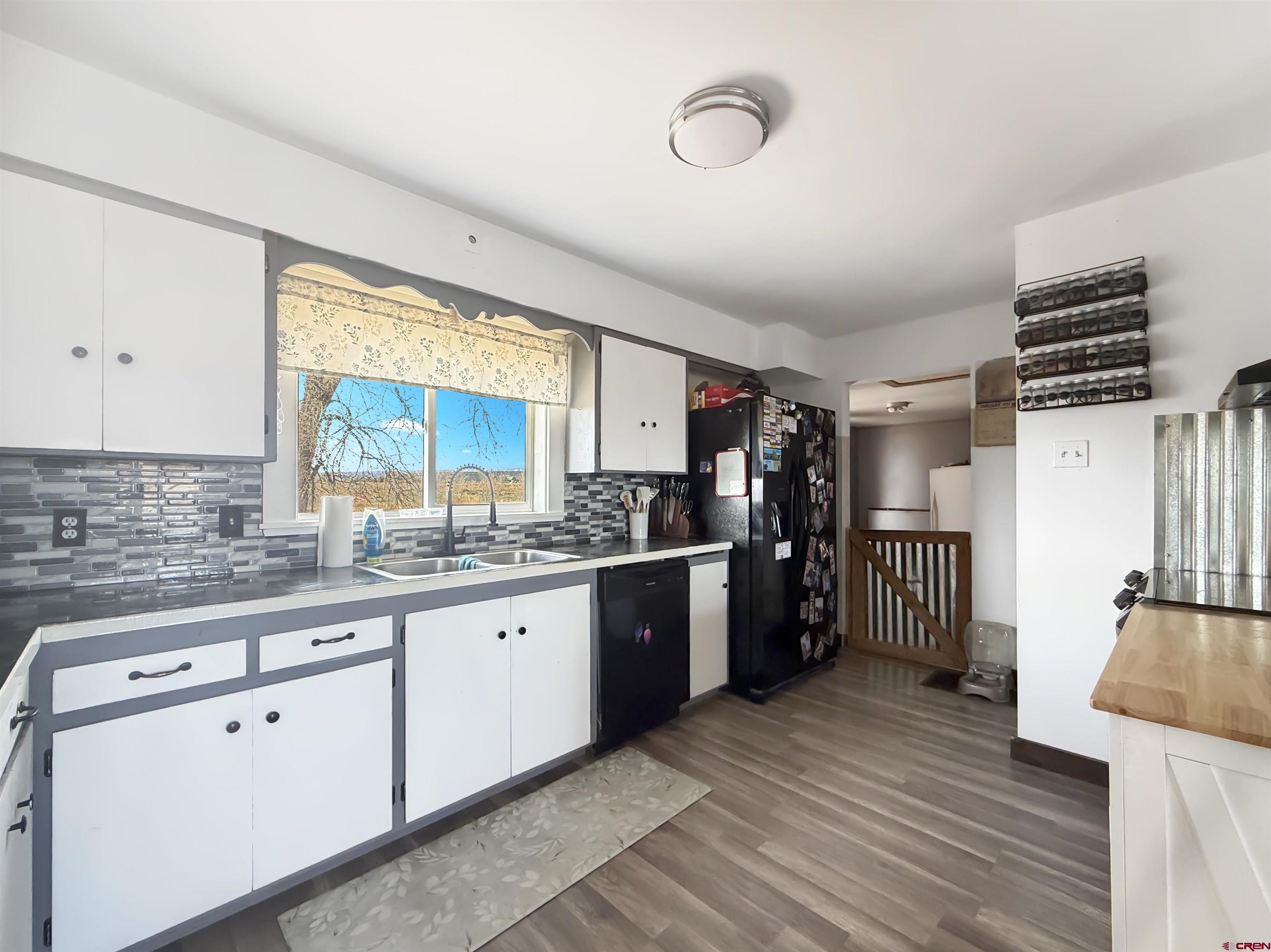 10659 3100th Road Hotchkiss, CO 81419 - Photo 6 of 40 a large kitchen with a lot of cabinets and wooden floor