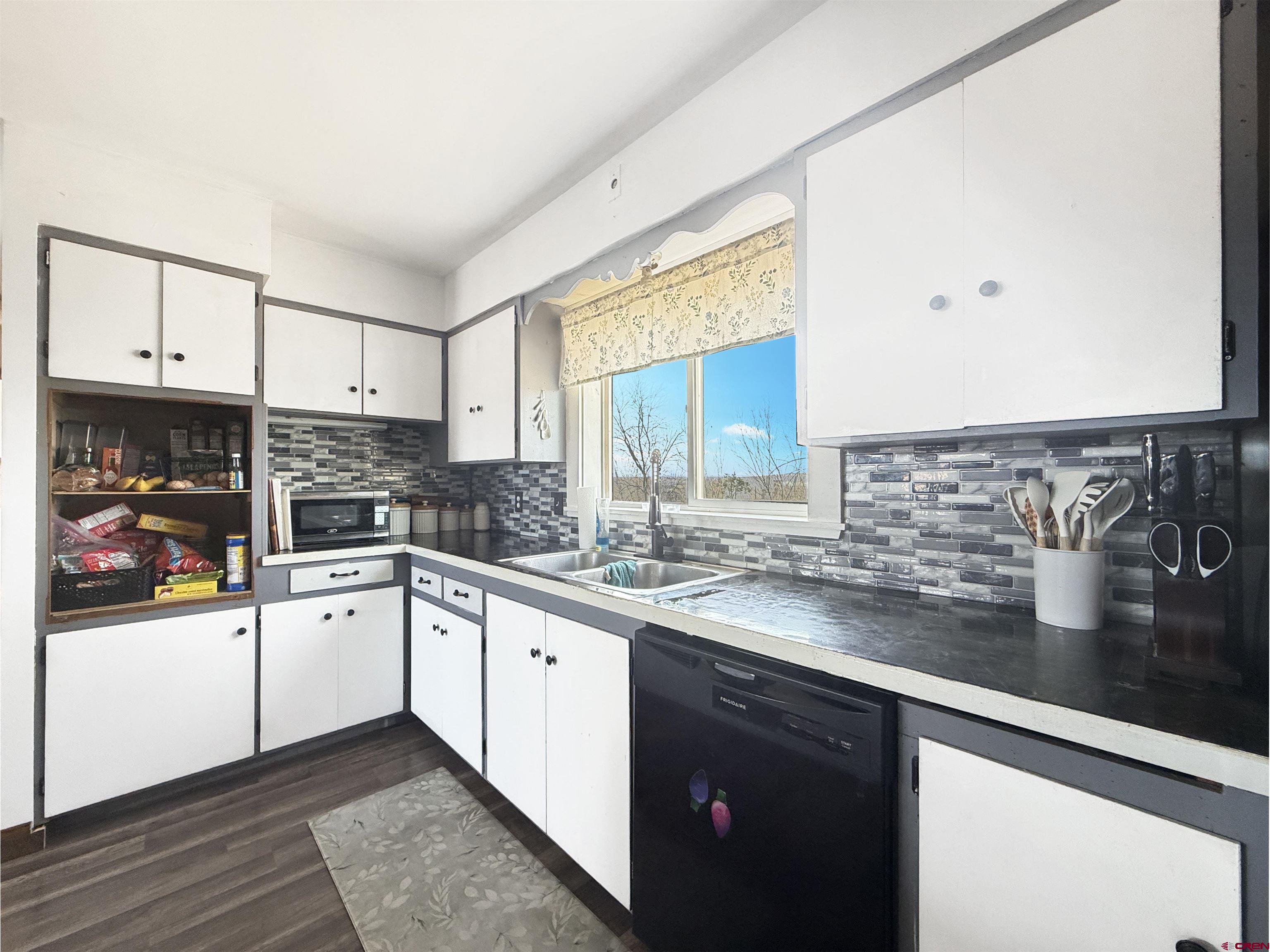 10659 3100th Road Hotchkiss, CO 81419 - Photo 7 of 40 a kitchen with stainless steel appliances granite countertop a sink stove and cabinets