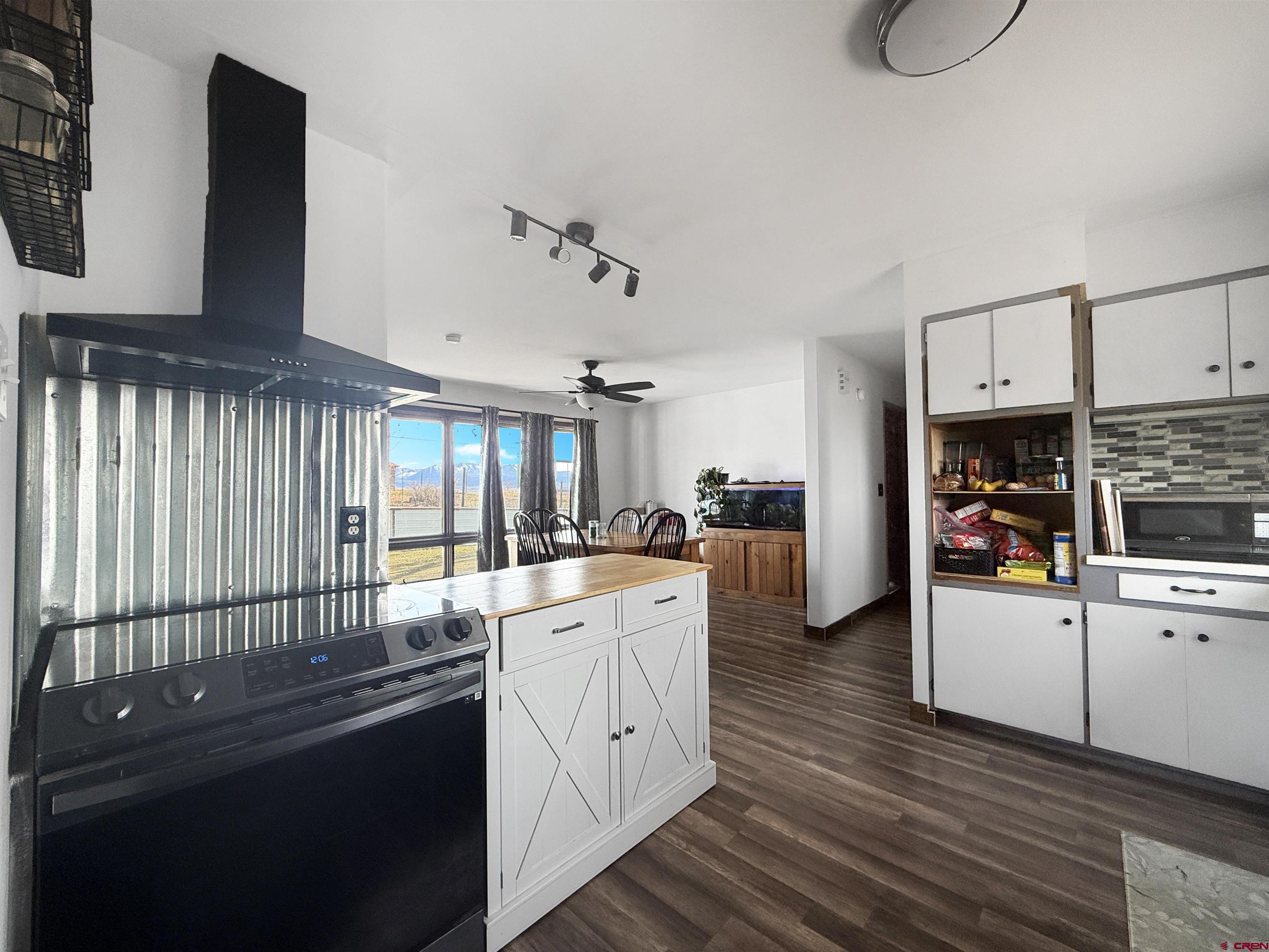 10659 3100th Road Hotchkiss, CO 81419 - Photo 8 of 40 a kitchen with white cabinets and sink
