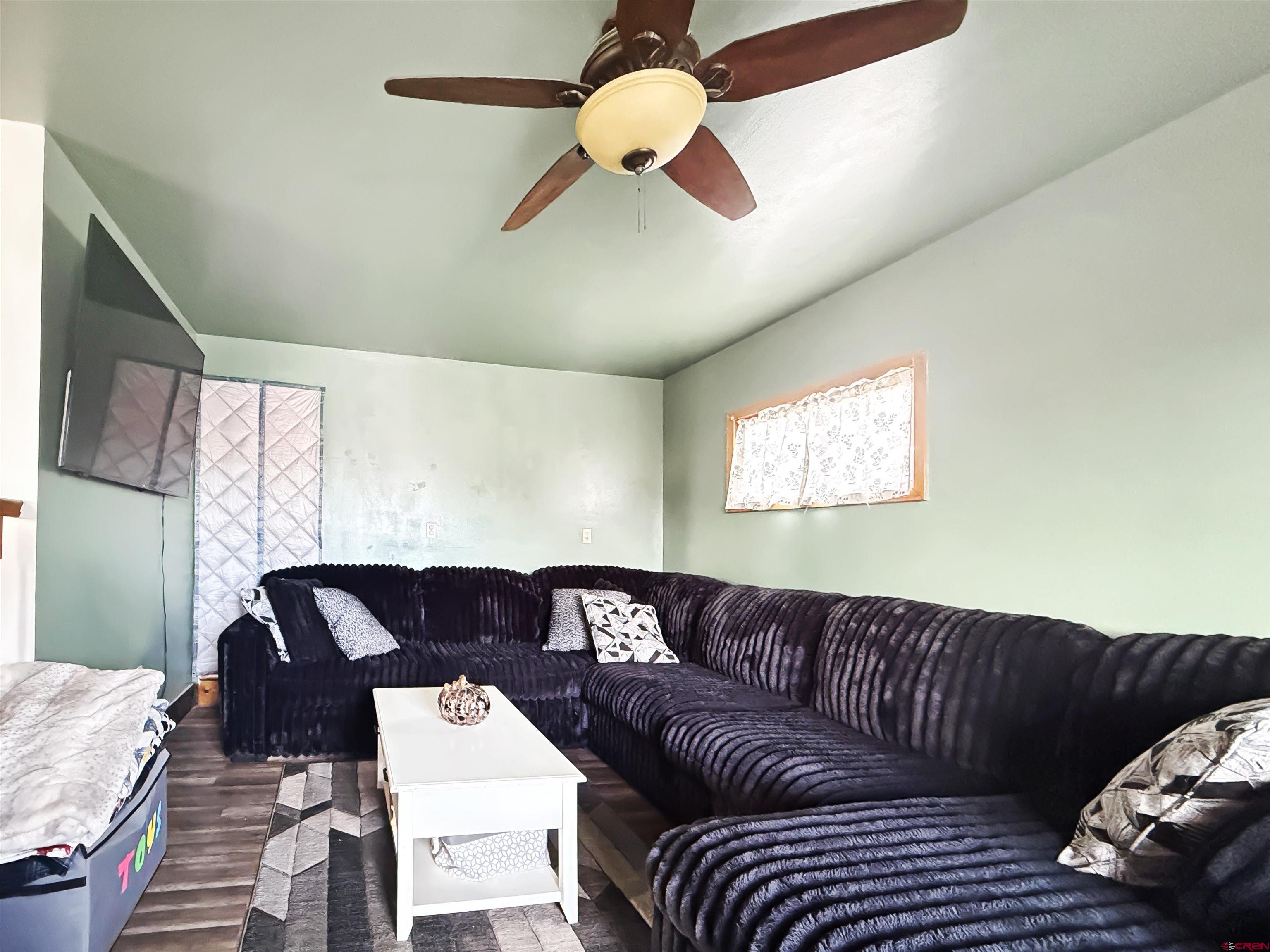 10659 3100th Road Hotchkiss, CO 81419 - Photo 10 of 40 a living room with furniture and a chandelier