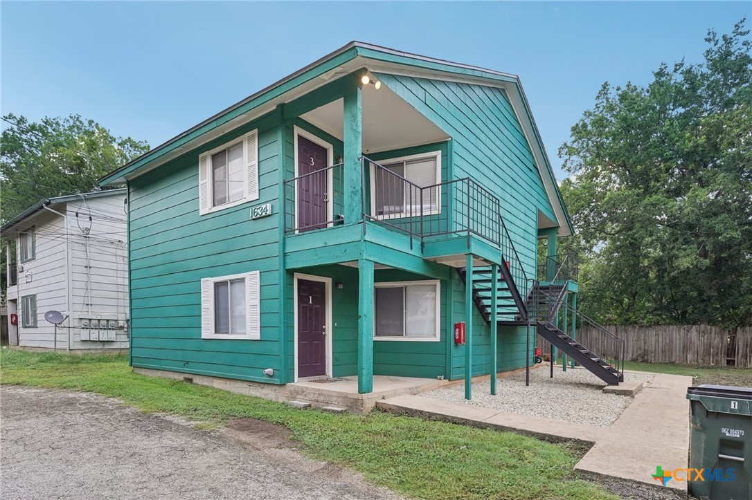 1634 Post Road, Unit 4 San Marcos, TX 78666 - Photo 2 of 11 a front view of a house with garden