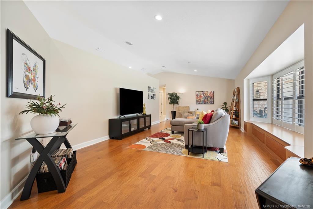 4620 Southeast Quail Trail Stuart, FL 34997 - Photo 26 of 71 a living room with furniture a flat screen tv and a large window