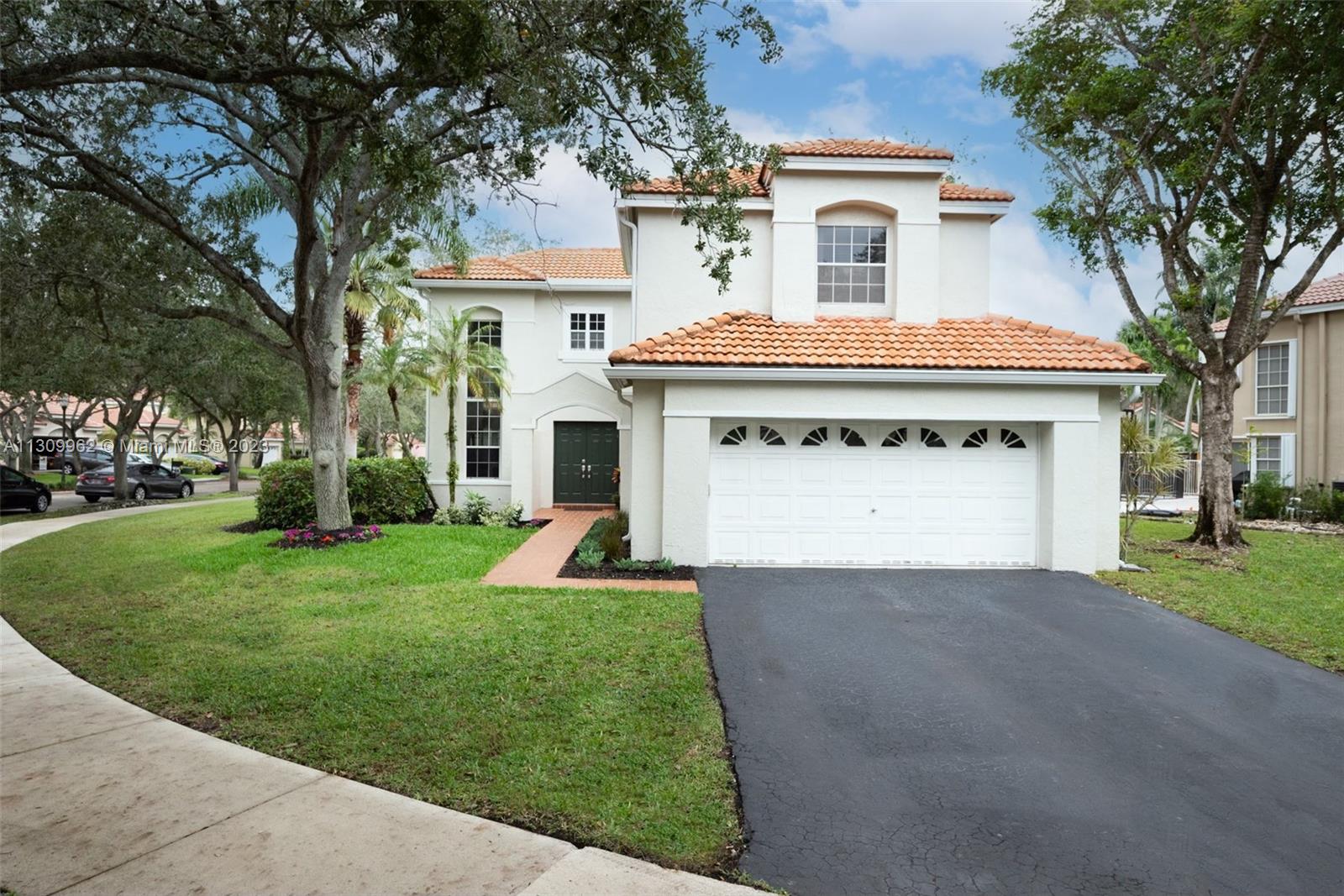 1295 Bayview Circle Weston, FL 33326 - Photo 1 of 1 a front view of a house with a yard and garage