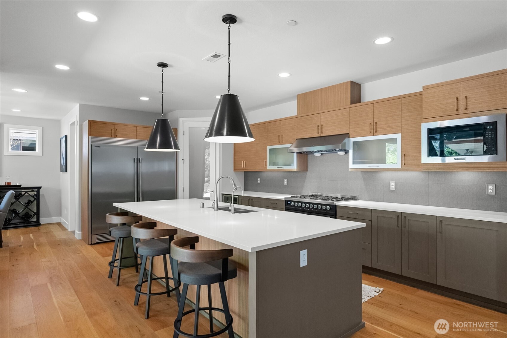 6565 Serenity Loop Gig Harbor, WA 98335 - Photo 11 of 40 a kitchen with stainless steel appliances granite countertop a sink a stove and a refrigerator