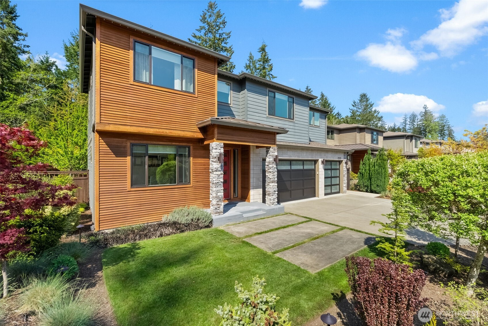 6565 Serenity Loop Gig Harbor, WA 98335 - Photo 2 of 40 a front view of a house with garden