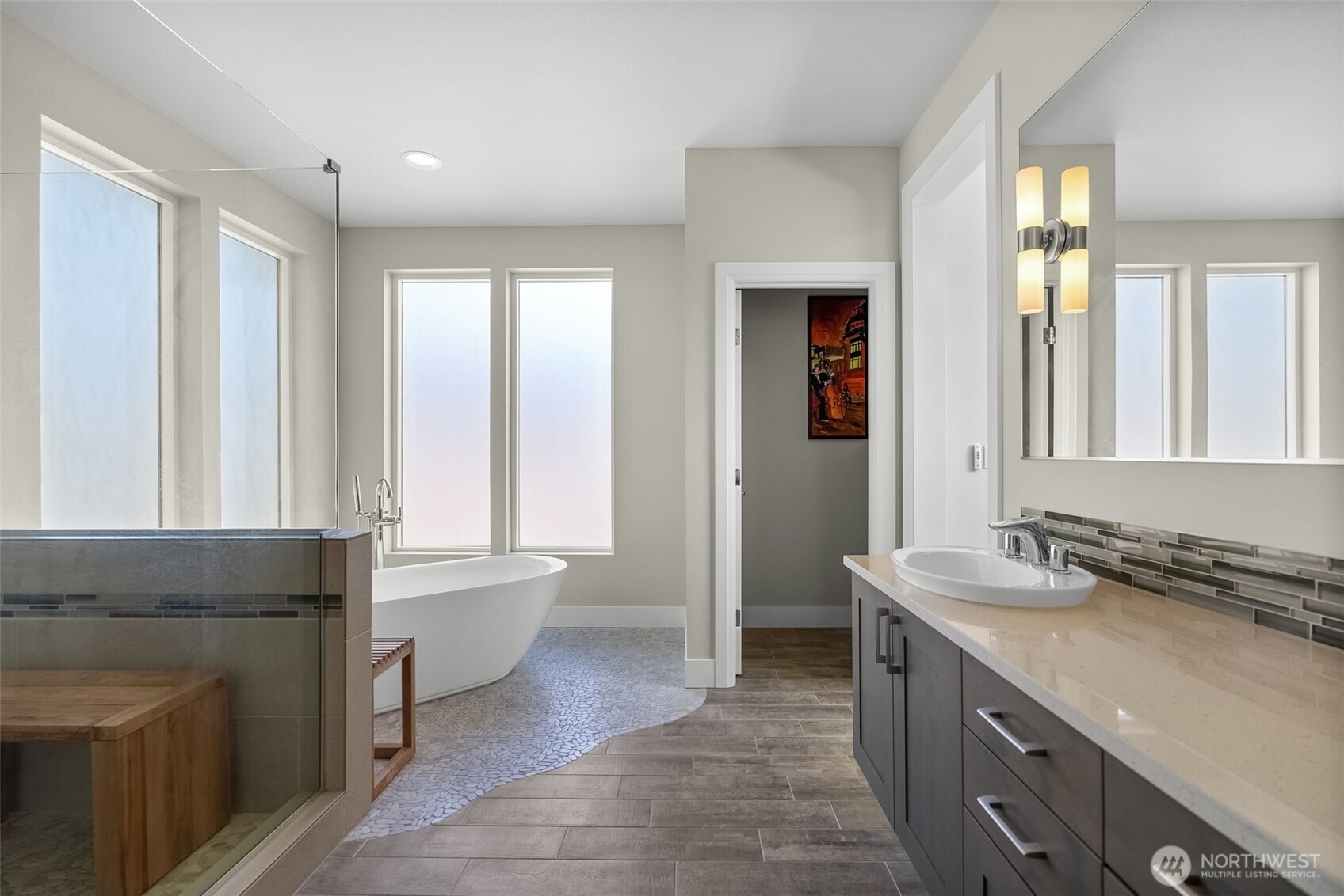 6565 Serenity Loop Gig Harbor, WA 98335 - Photo 27 of 40 a spacious bathroom with a granite countertop tub sink and mirror
