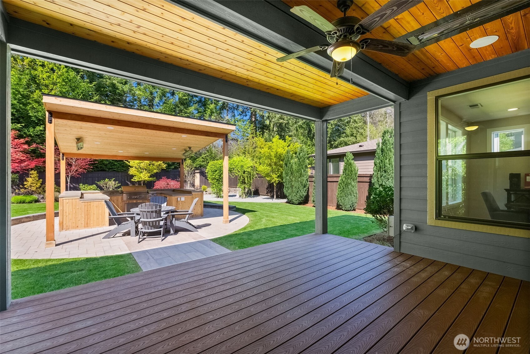 6565 Serenity Loop Gig Harbor, WA 98335 - Photo 33 of 40 a view of a patio with wooden floor table and chairs