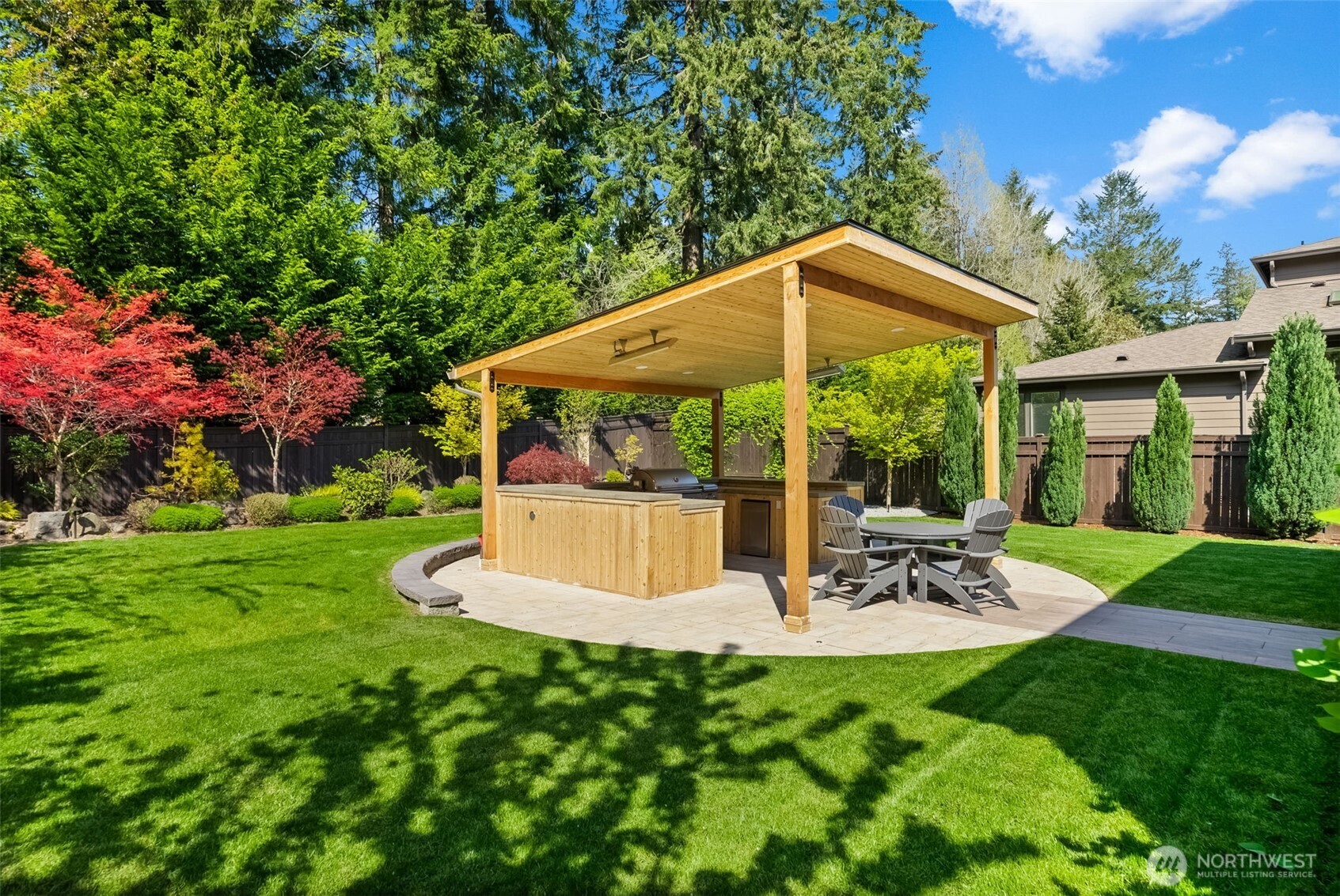 6565 Serenity Loop Gig Harbor, WA 98335 - Photo 35 of 40 a view of a chair and table in backyard of the house