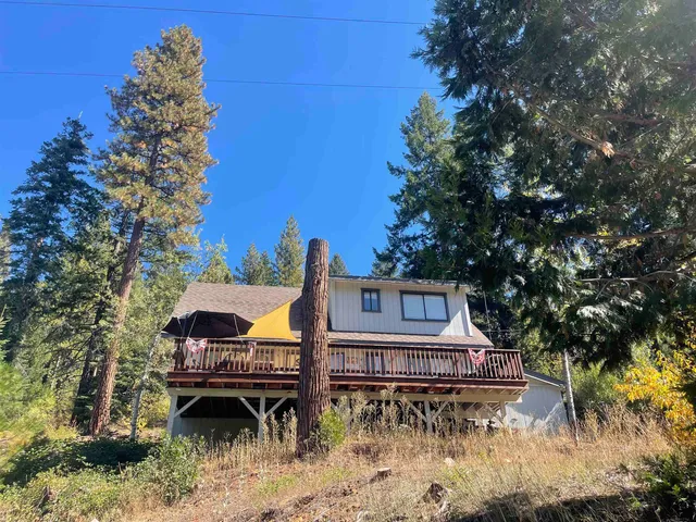 a backyard of a house with table and chairs