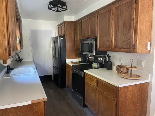 a kitchen with a sink a stove and refrigerator
