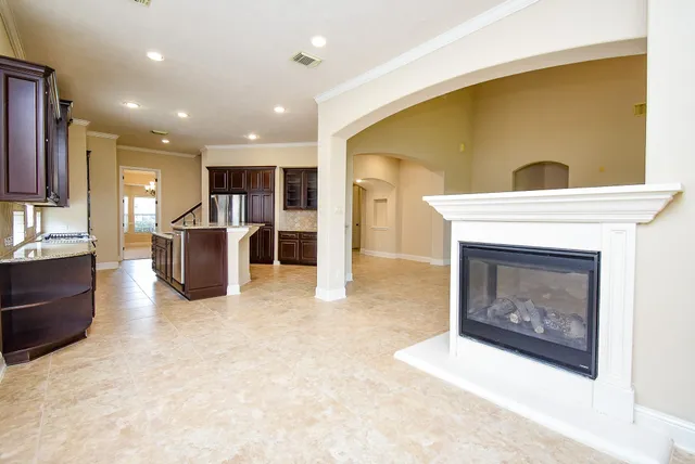 a view of kitchen with kitchen island granite countertop furniture and a fireplace
