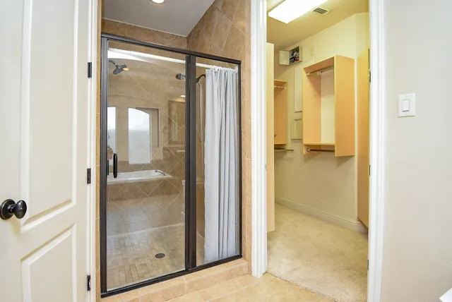 a bathroom with a glass shower door
