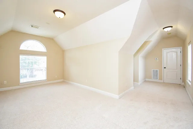 an empty room with a empty space and windows