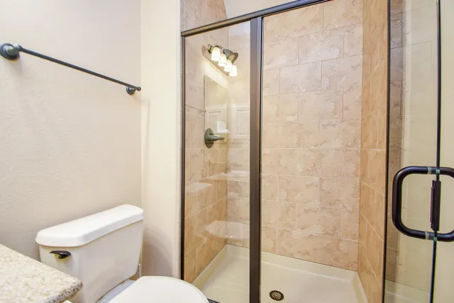 a white toilet sitting next to a bathroom sink