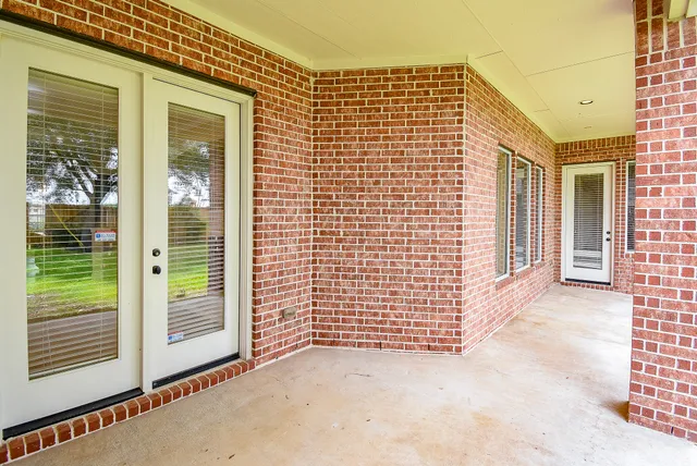 a view of a brick house with large windows