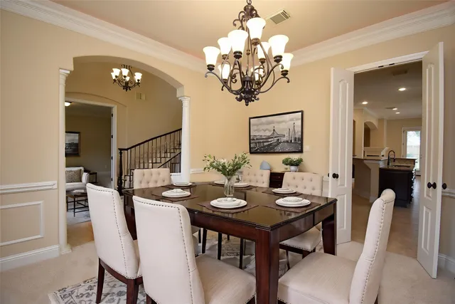 a view of a dining room with furniture and chandelier