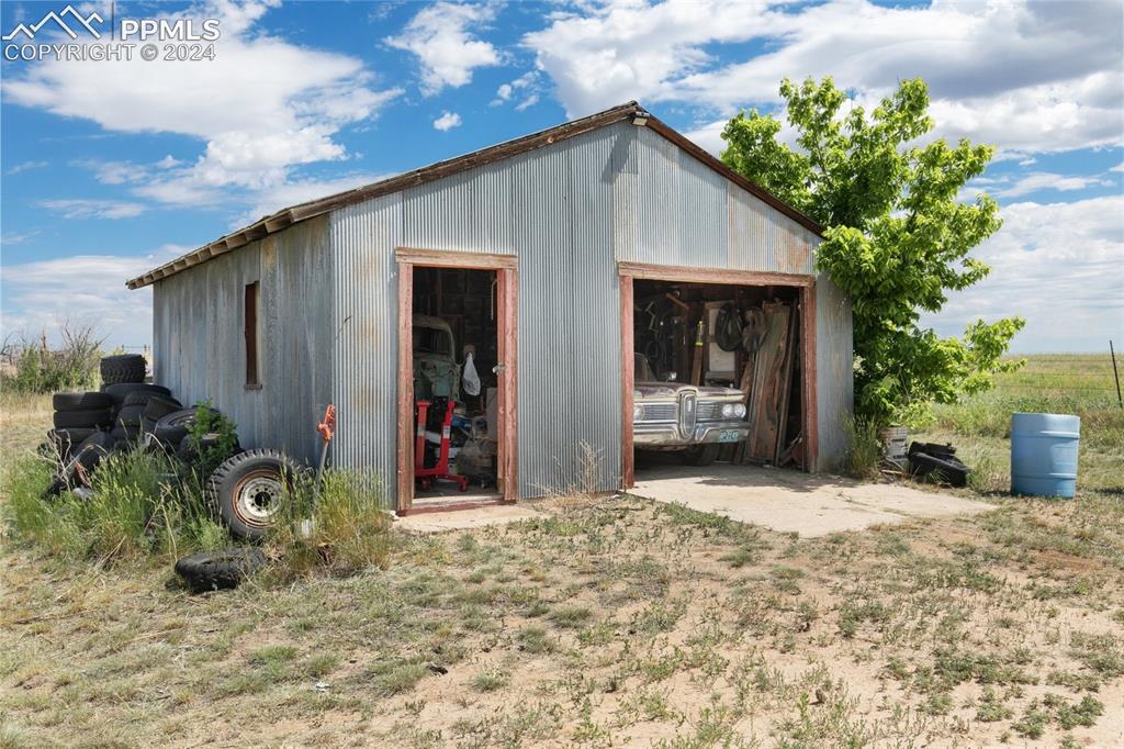 40150 Rapp Road Rush, CO 80833 - Photo 30 of 39 a front view of a house with a yard and potted plants