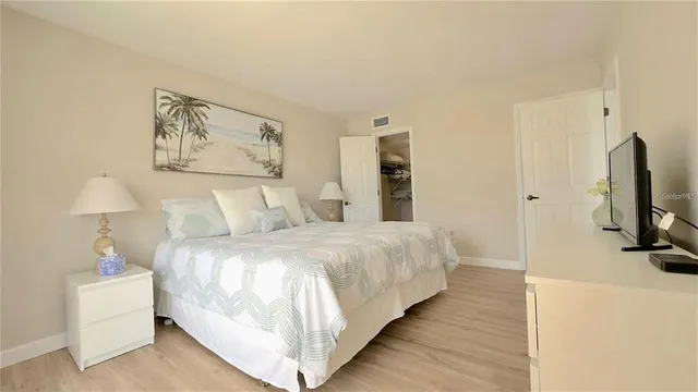 a bedroom with double bed and a flat tv screen on the dresser