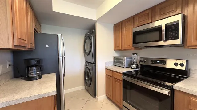 a kitchen with stainless steel appliances a stove a microwave and a sink