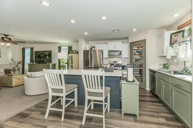 a dining room with furniture and wooden floor