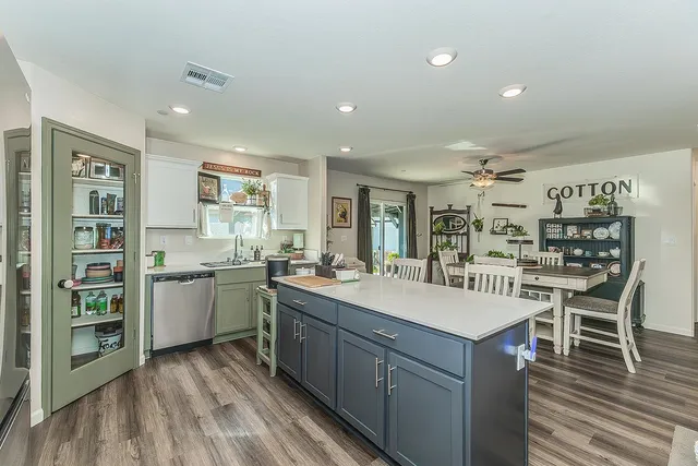 a large kitchen with a counter space a sink and appliances