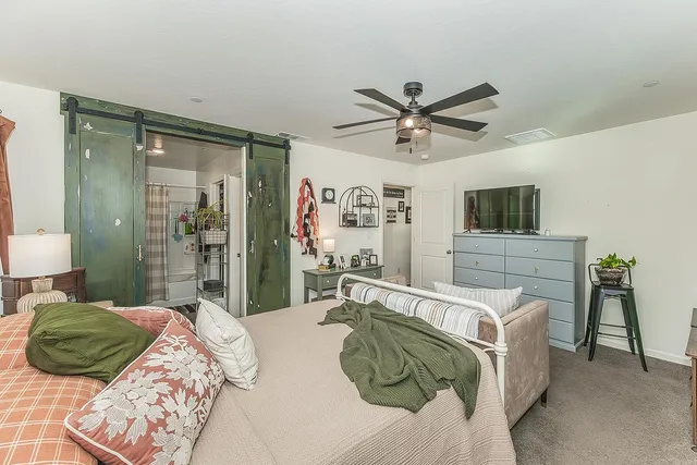 a bedroom with a bed and a television