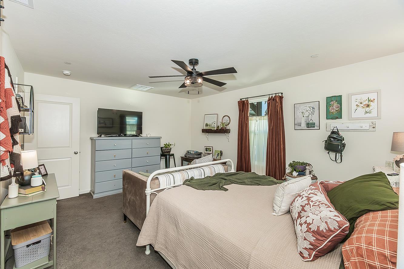 2161 Heidi Avenue Sanger, CA 93657 - Photo 19 of 43 a bedroom with a bed and a flat screen tv