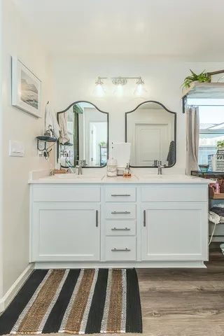 a spacious bathroom with a double vanity sink and a mirror