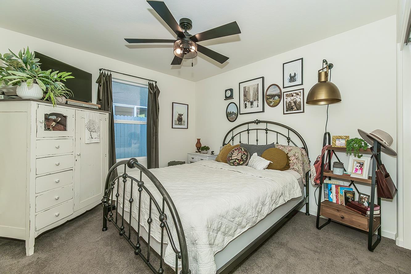 2161 Heidi Avenue Sanger, CA 93657 - Photo 28 of 43 a bedroom with a bed a dresser and potted plants