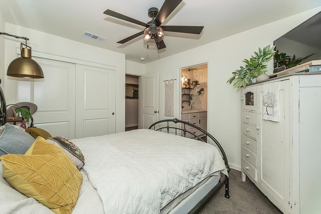 2161 Heidi Avenue Sanger, CA 93657 - Photo 29 of 43 a bedroom with a bed and a chandelier