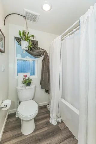 a bathroom with a toilet and a shower