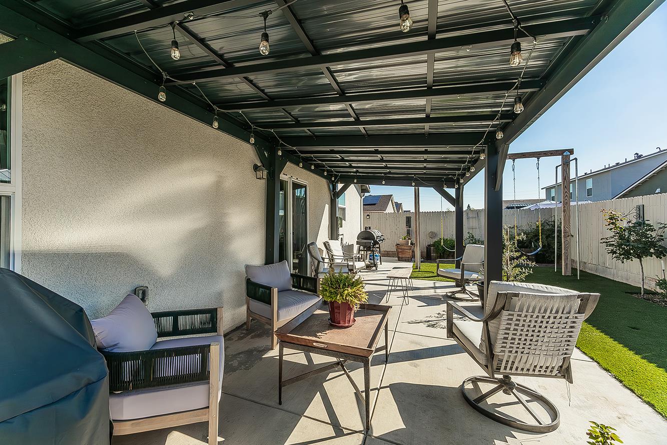 2161 Heidi Avenue Sanger, CA 93657 - Photo 36 of 43 a view of a patio with chairs and floor to ceiling window with wooden floor