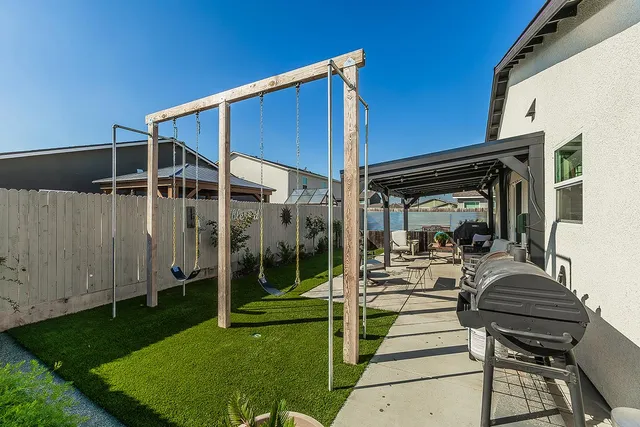 a view of a house with backyard and porch