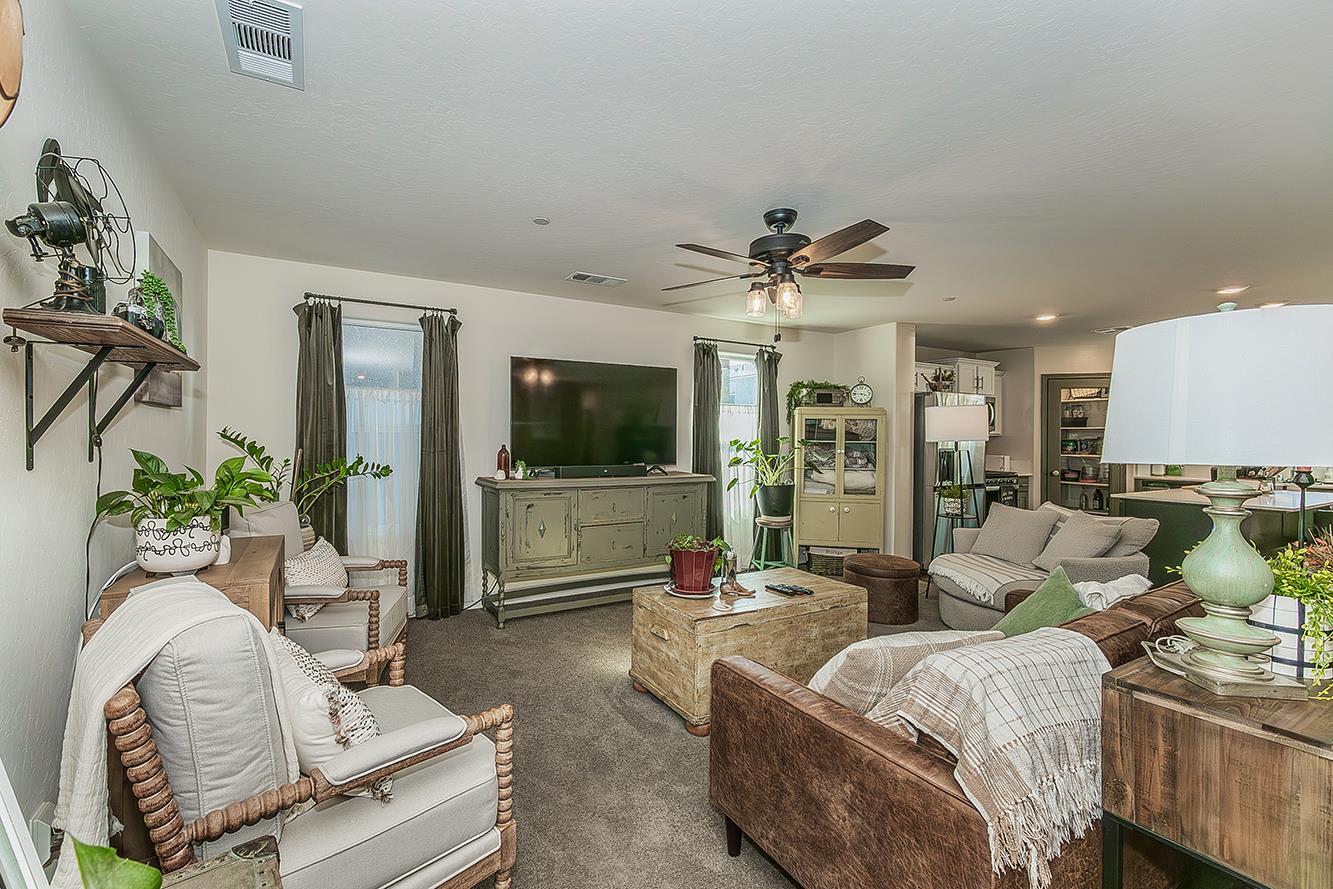 2161 Heidi Avenue Sanger, CA 93657 - Photo 4 of 43 a living room with furniture a flat screen tv and a large window