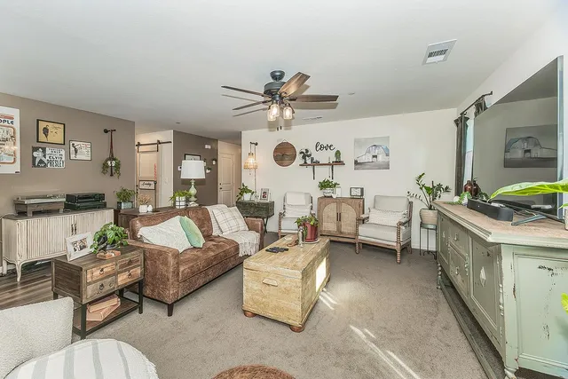 a living room with furniture and a clock