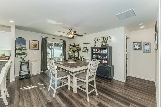 a view of a dining room with furniture and wooden floor