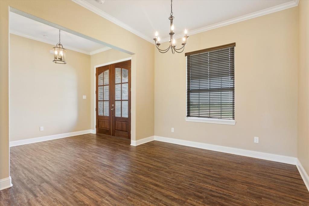 14356 China Spring Road China Spring, TX 76633 - Photo 5 of 36 a view of an empty room with wooden floor and a window