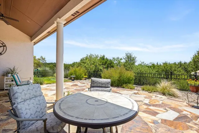 a view of a chair and table in the patio