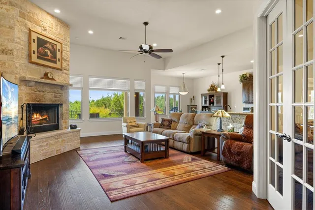 a living room with furniture fireplace and a large window